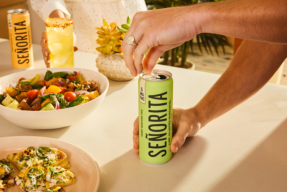 Someone opening a can of Señorita THC Margarita